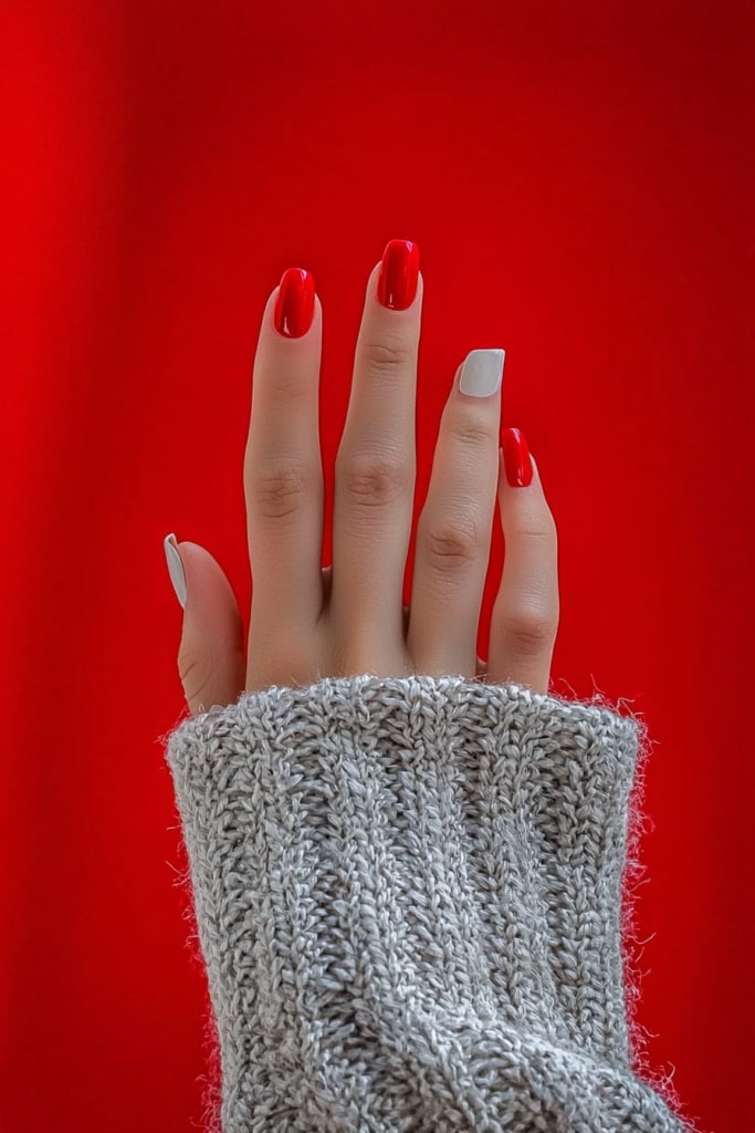 White and red Christmas nails with cozy gray knit sweater