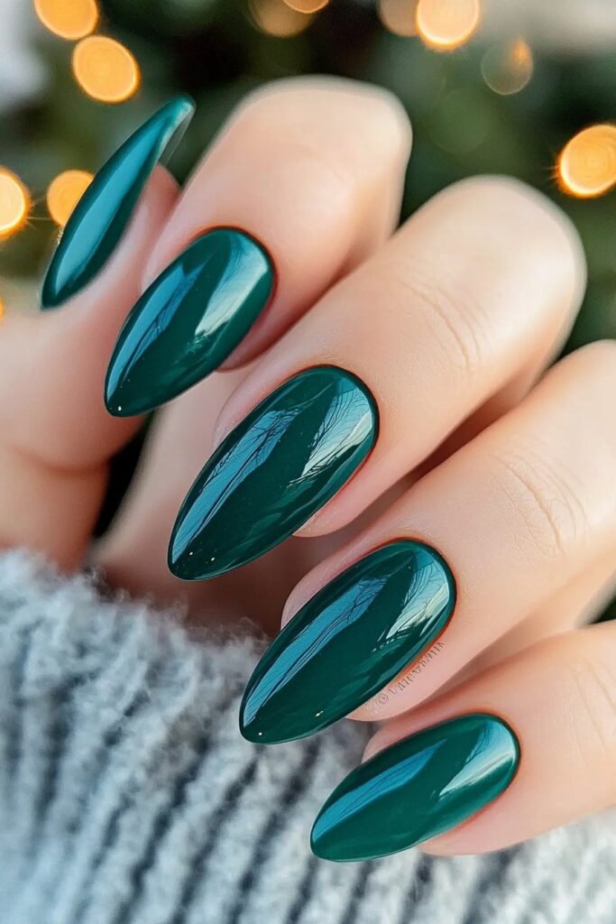 Glossy emerald green almond nails for elegant Christmas manicure