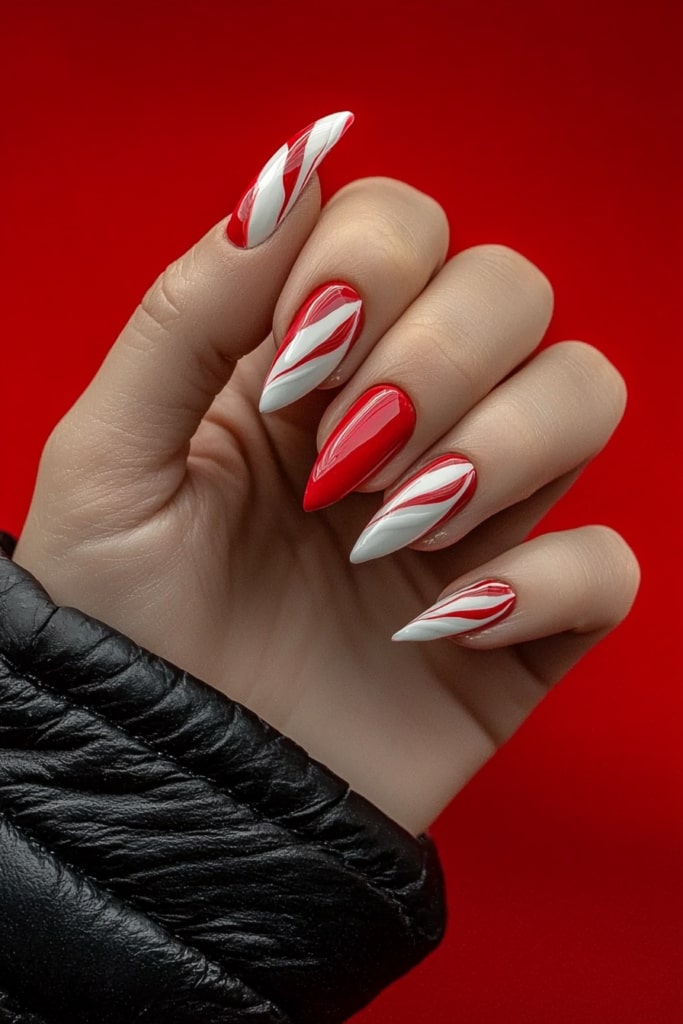 Pink and white Christmas nails with candy cane swirl pattern