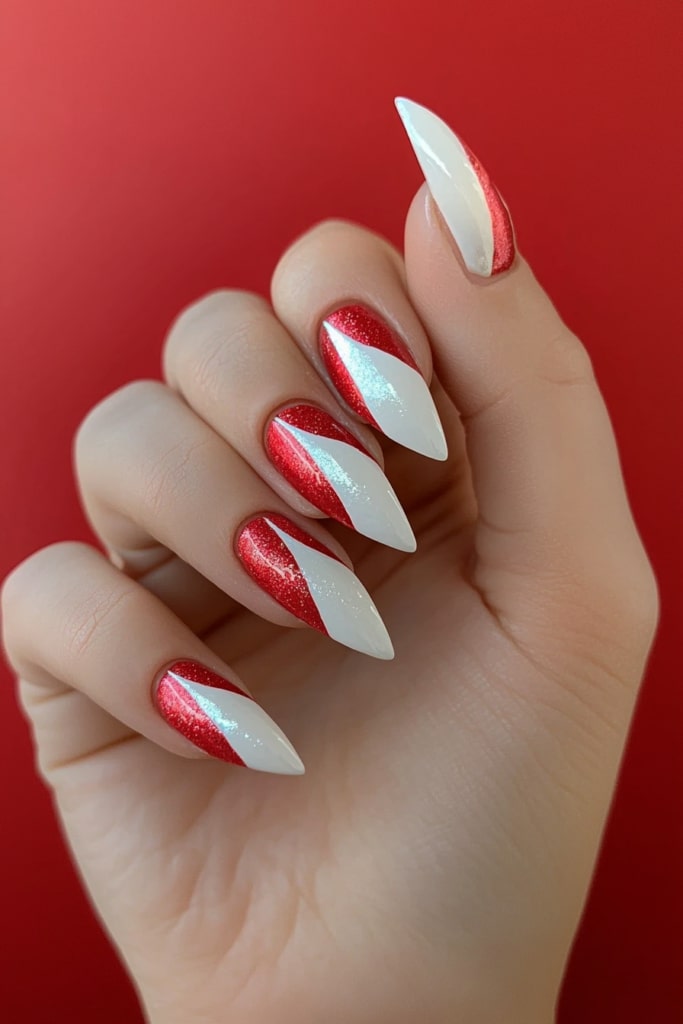 Glittery red and white diagonal Christmas nail design with stiletto tips