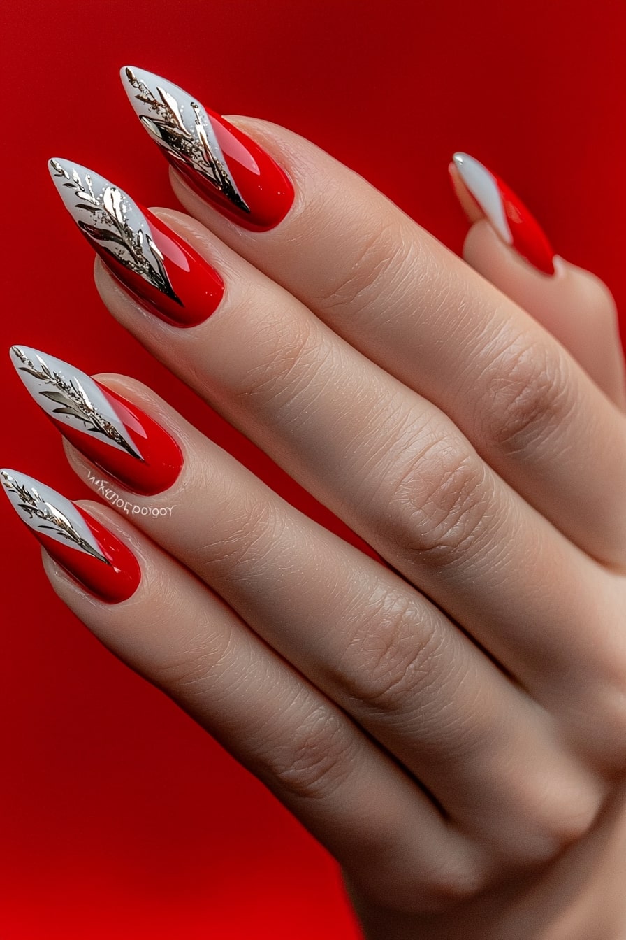 Elegant Christmas nails with red base and silver leaf details