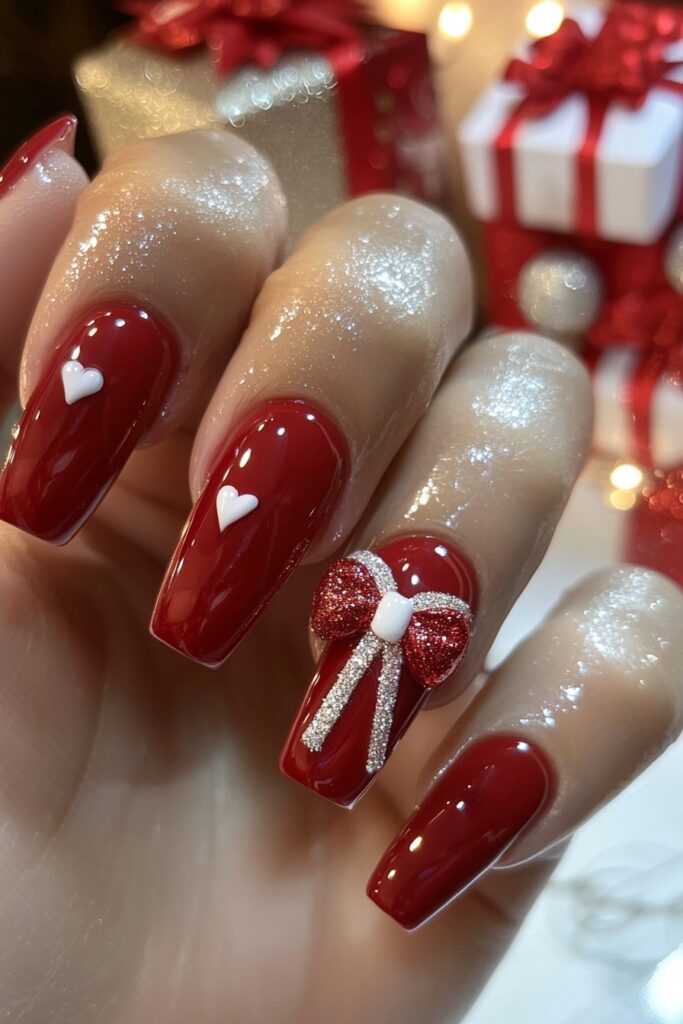 Christmas red acrylic nail designs with 3D bow accents.