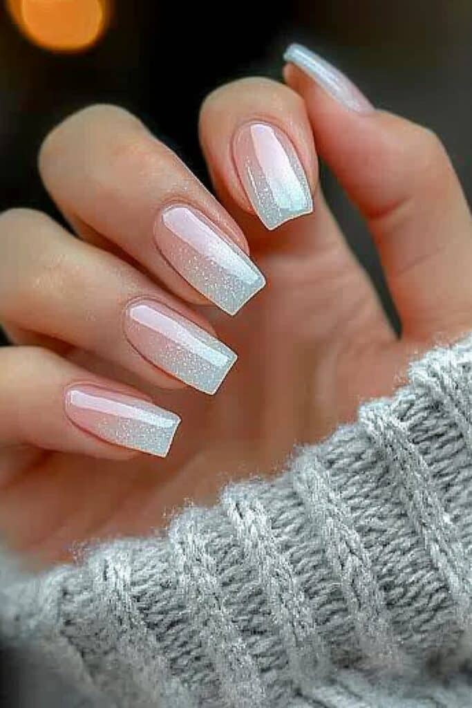 Blush-toned nails with frosty shimmer details.