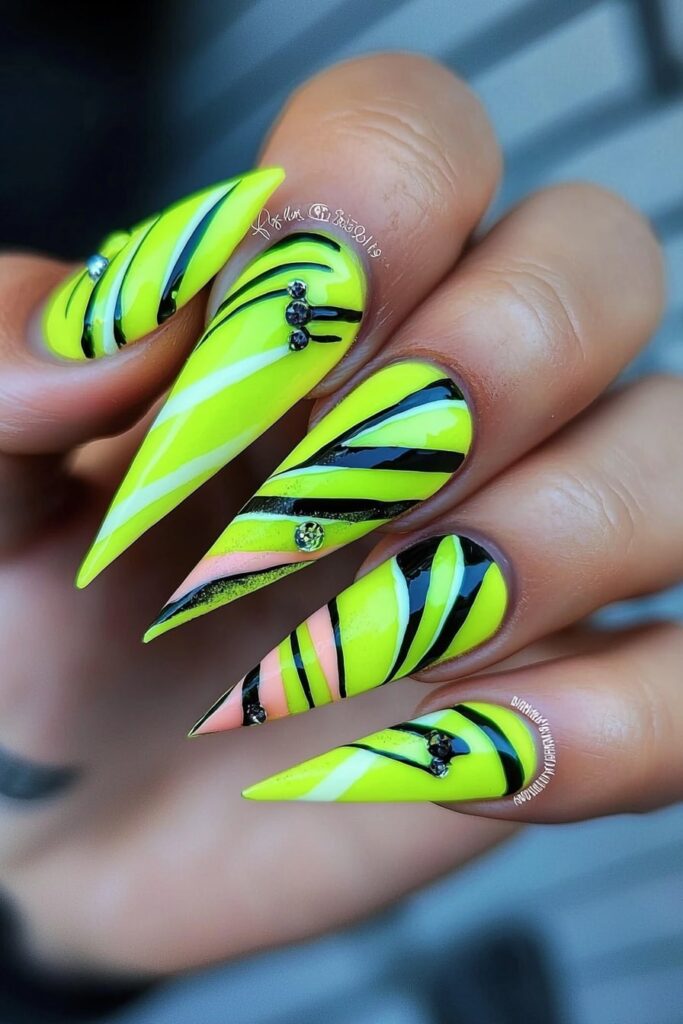 Wicked pink and neon green stiletto nails with striped design