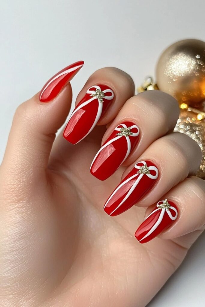 Christmas red acrylic nails with bow design accents