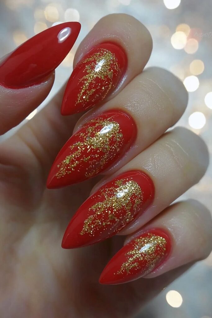 Christmas almond nails with red polish and gold glitter accents