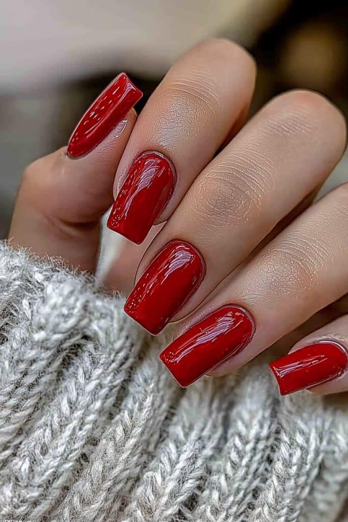 Short neutral winter nails in glossy cranberry red