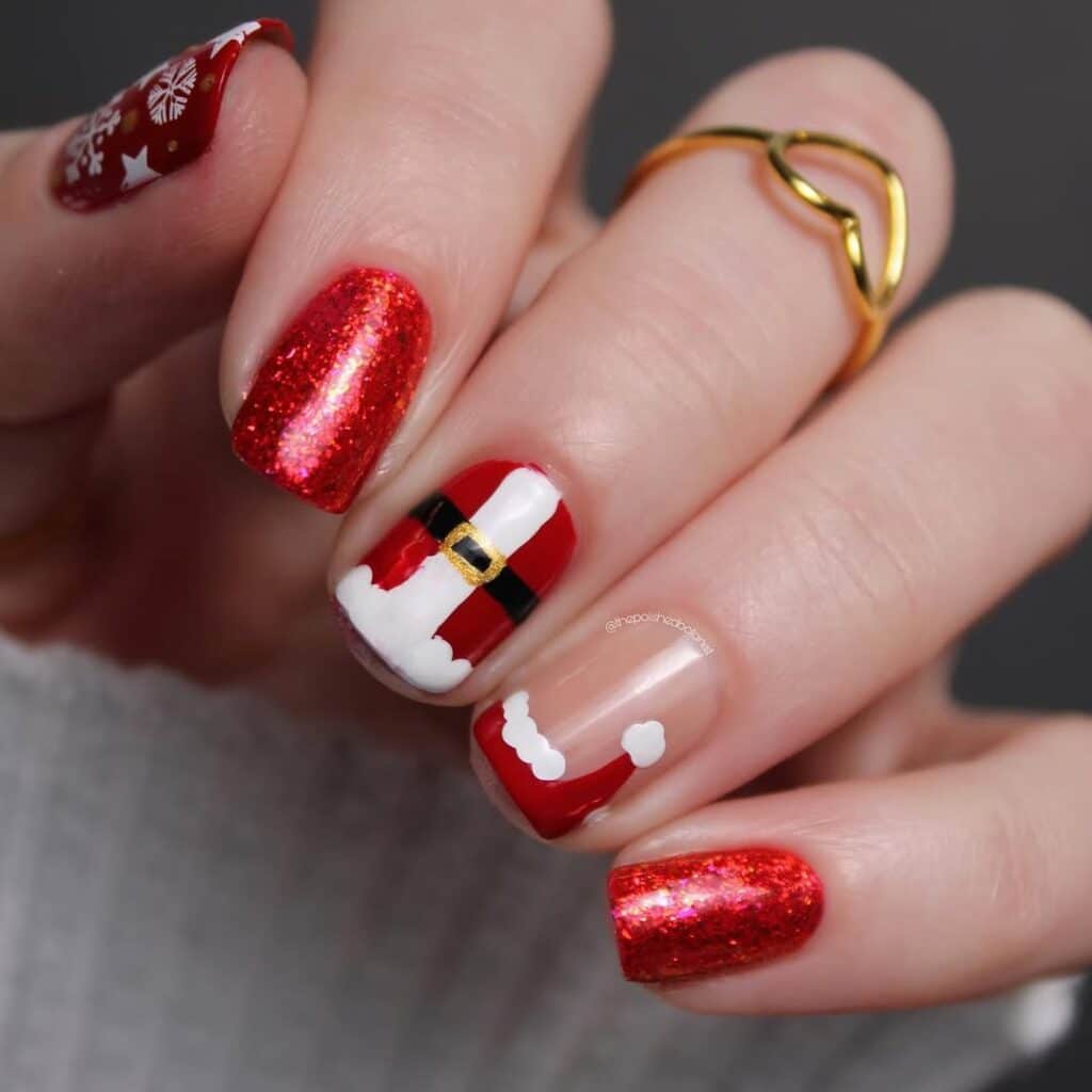 Christmas red acrylic nails featuring Santa suit and sparkly design