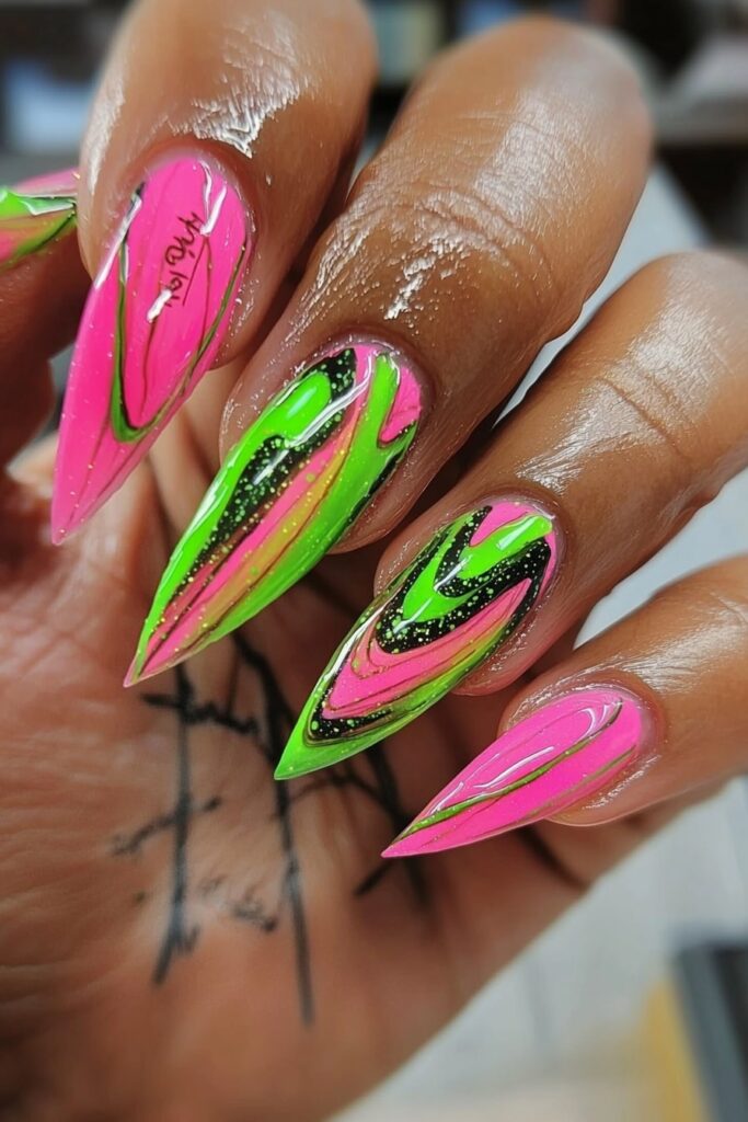 Wicked nails pink and green swirled galaxy stiletto design