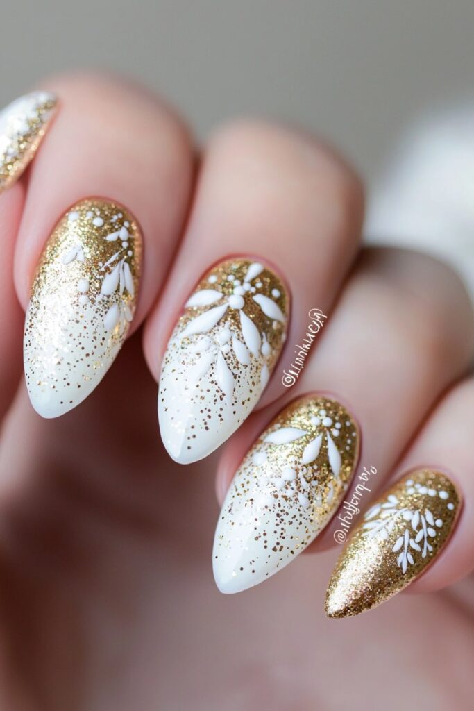 Christmas acrylic almond nails with gold glitter and white snowflakes