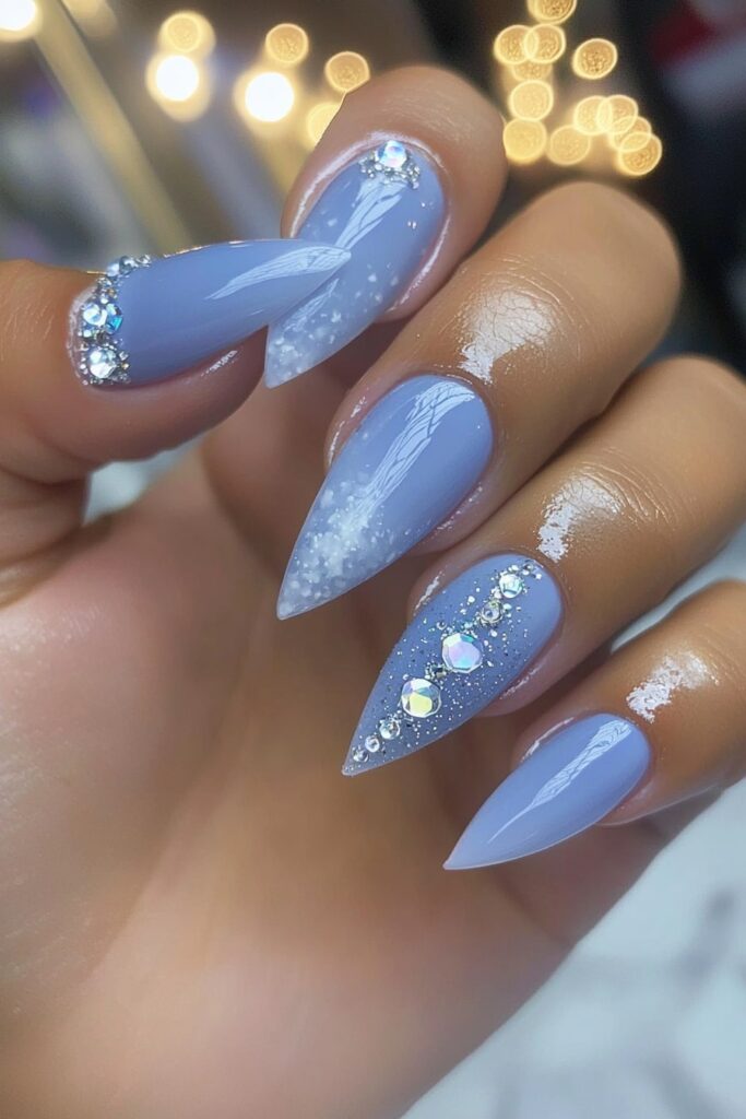 Christmas acrylic almond nails in icy blue with rhinestones