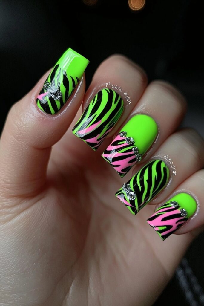 Wicked neon green and pink zebra print nails with glitter accents