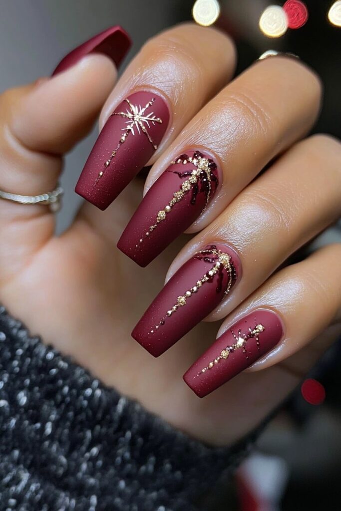 Coffin Christmas nails with burgundy matte and gold sparkle designs