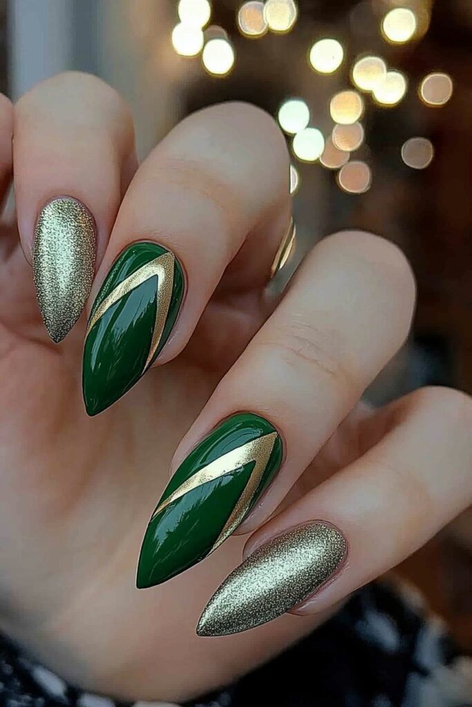 Wicked almond nails featuring emerald green with gold diagonal stripes