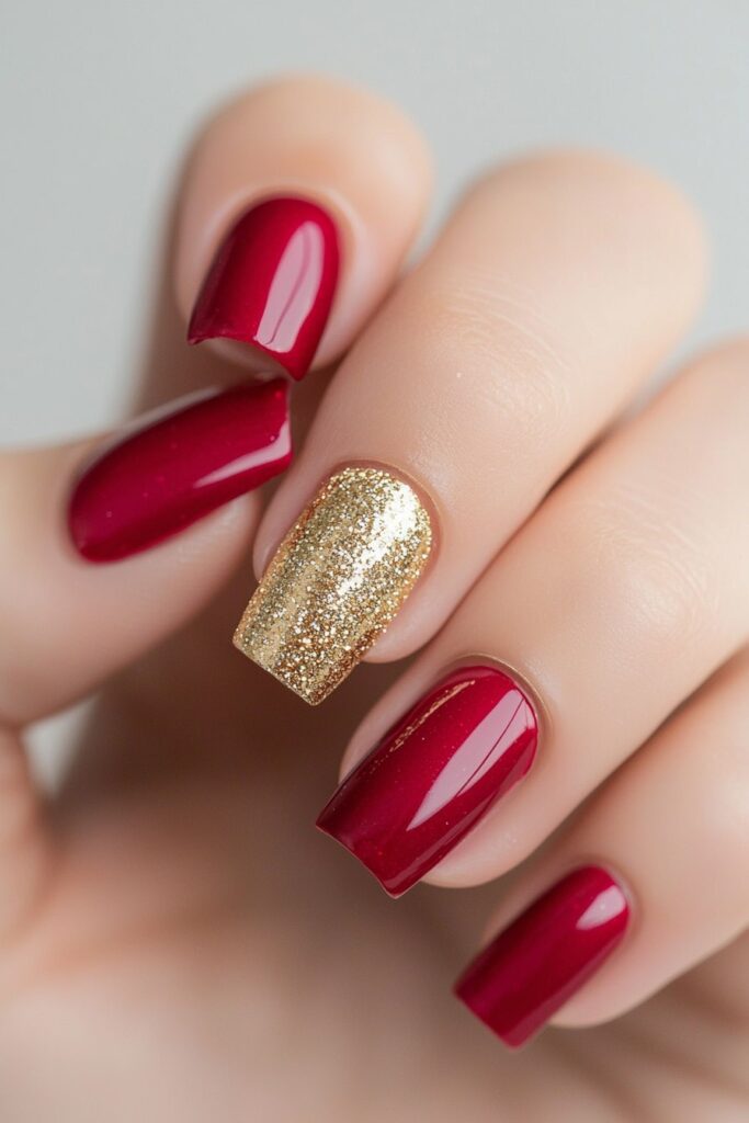 Coffin Christmas nails in burgundy red with gold glitter accent