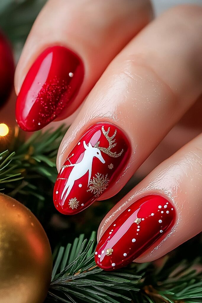 Christmas acrylic almond nails with red polish and reindeer