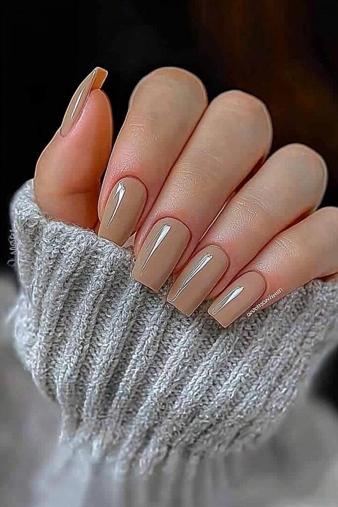 Sandy beige nails with a luxurious glossy finish.