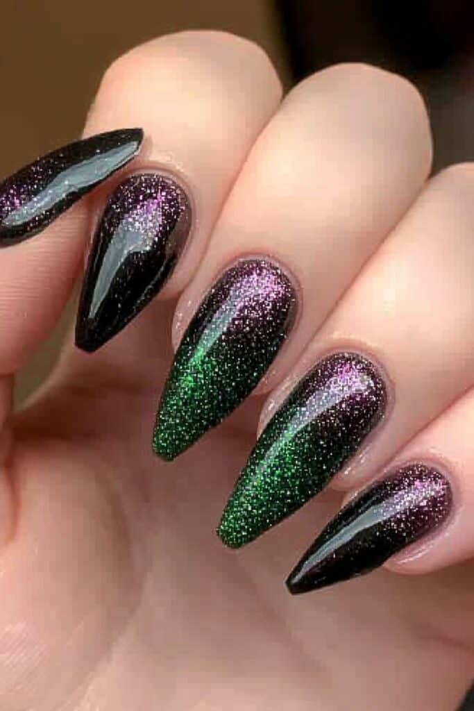 Wicked almond nails with black-green ombre and sparkly glitter