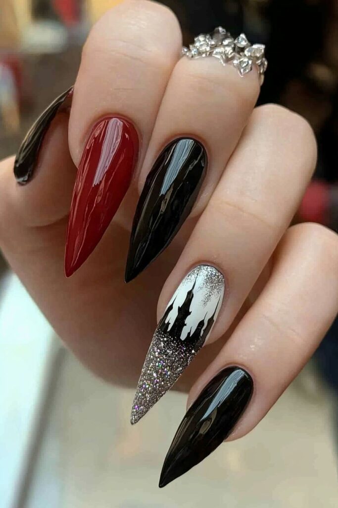 Almond wicked nails featuring castle silhouette, red and black polish