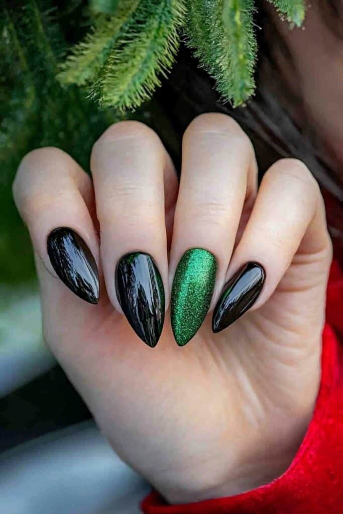 Wicked almond nails with black polish and emerald glitter accent