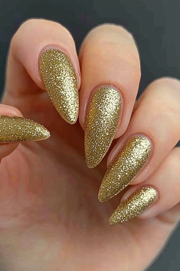 Wicked almond nails with sparkling golden glitter finish