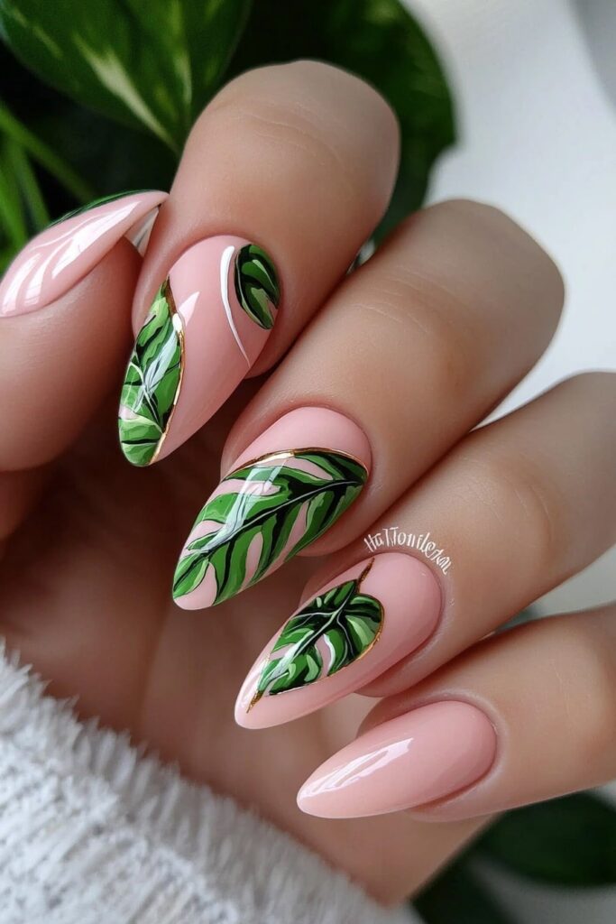 Pink stiletto nails with tropical green leaf designs