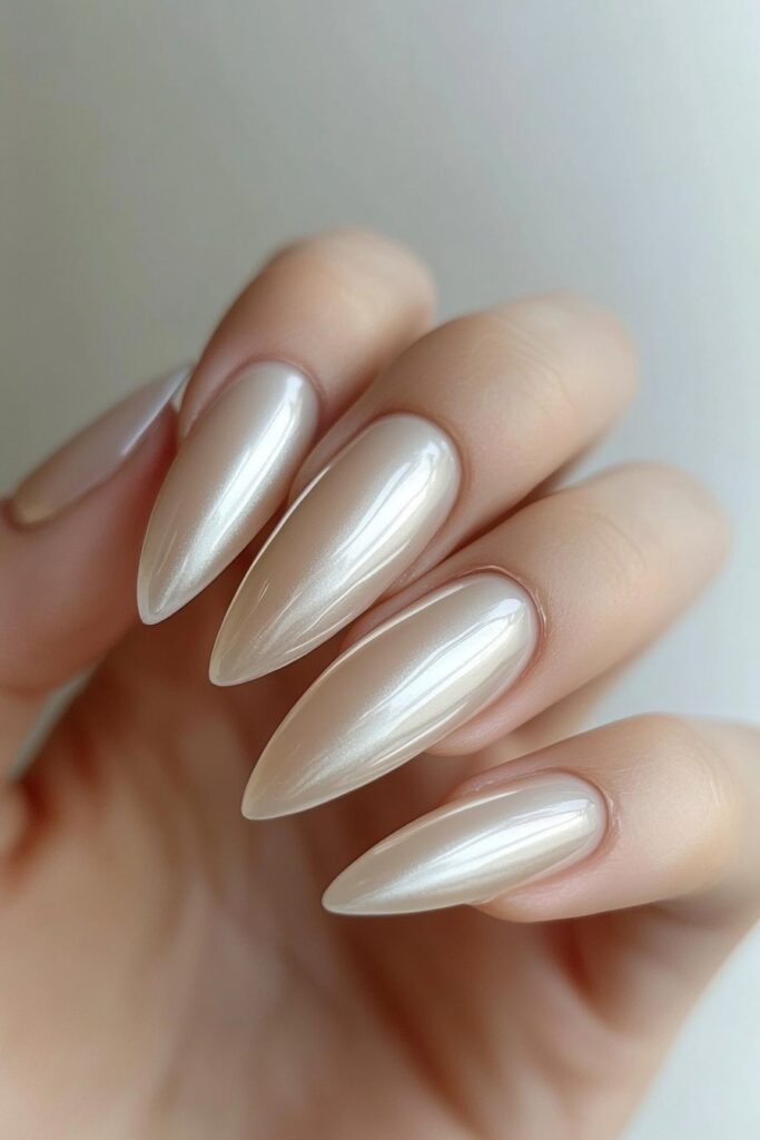 Almond-shaped nails with a sleek chrome glaze, featuring a high-shine, reflective mirror effect for a futuristic and luxurious look