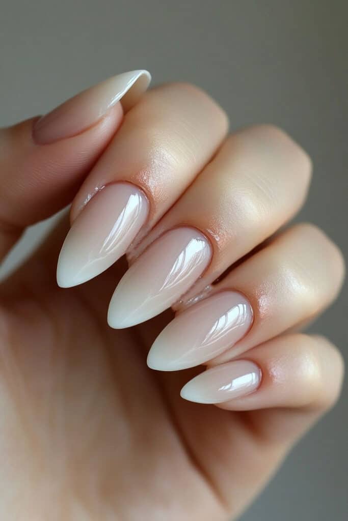 Almond-shaped nails with soft pastel French tips, offering a modern twist to the classic style with subtle color variation.