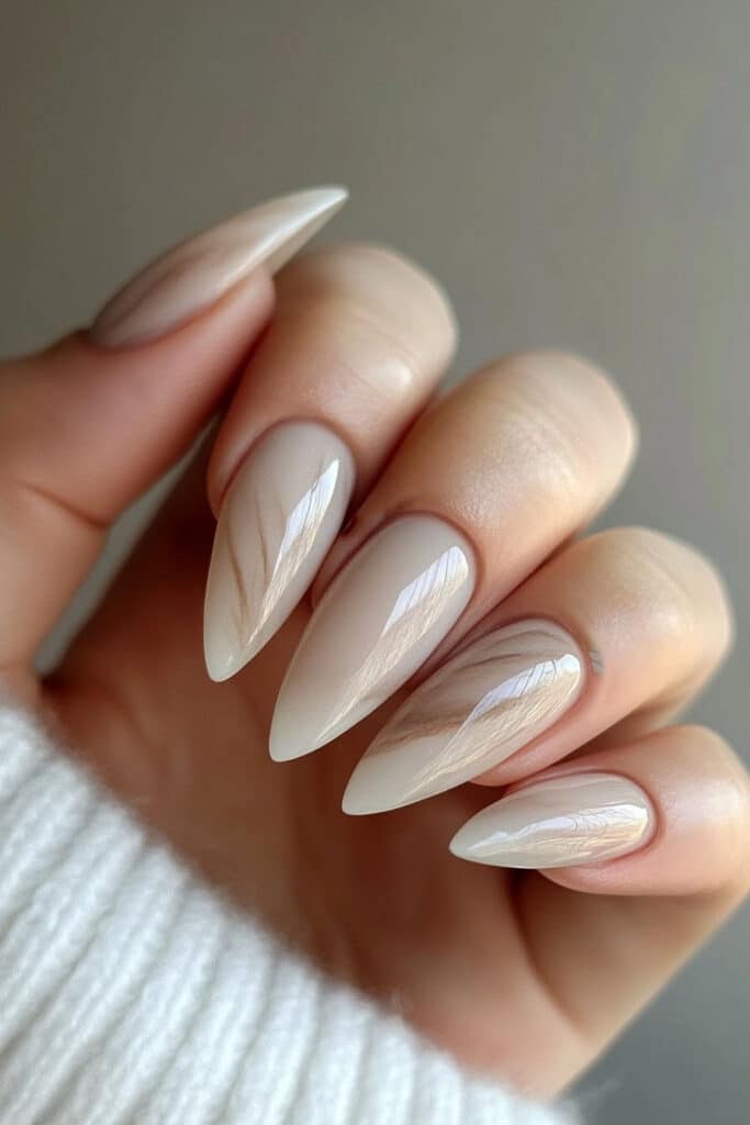 Almond-shaped nails with a luxurious matte marble effect, blending soft white and gray tones for a chic and sophisticated summer aesthetic.