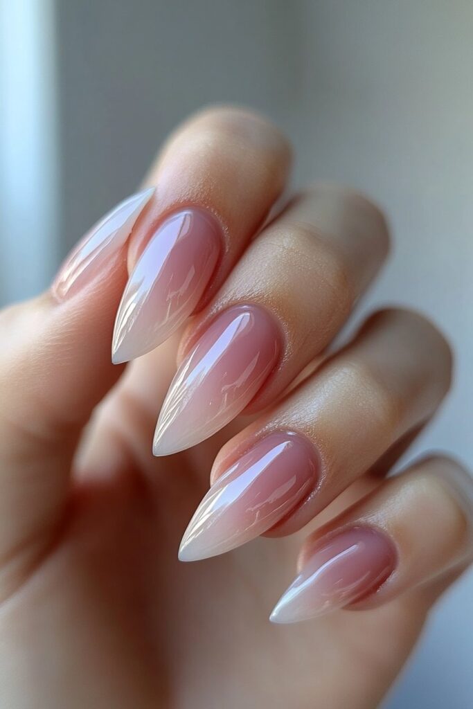 Almond-shaped nails with a dreamy pastel watercolor effect, blending soft pink, lavender, and baby blue hues for a delicate feel.