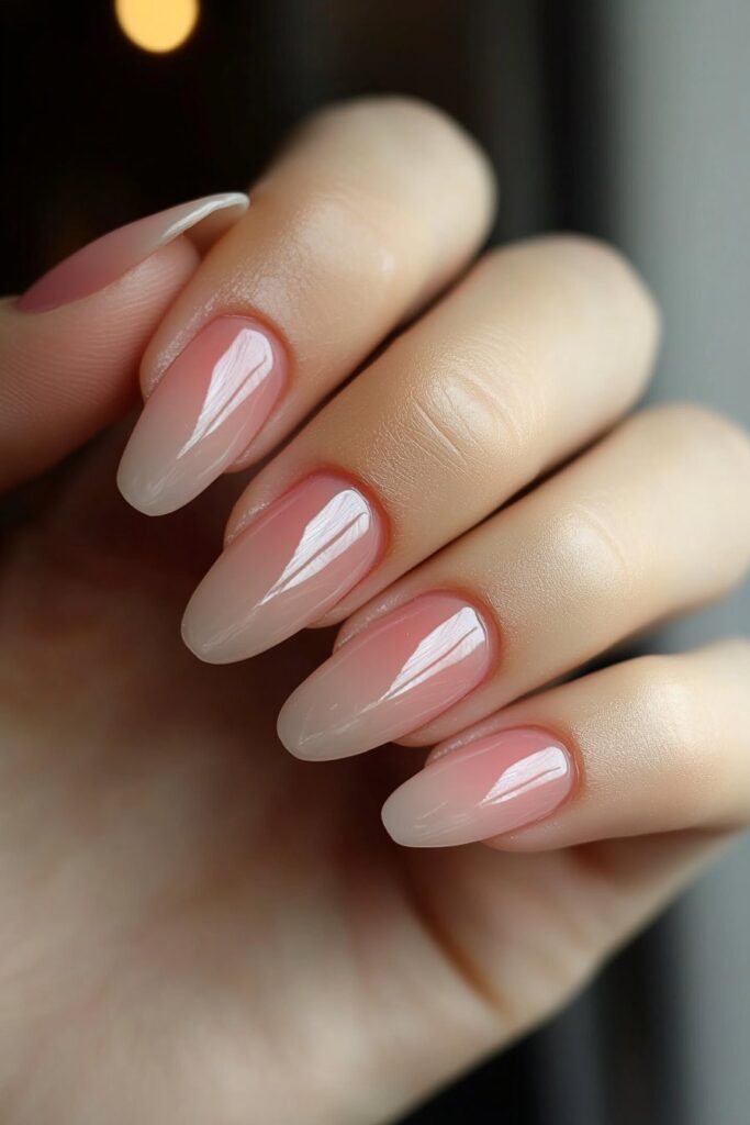 Timeless almond-shaped nails with a soft ombré effect, blending two complementary colors seamlessly for a polished appearance.