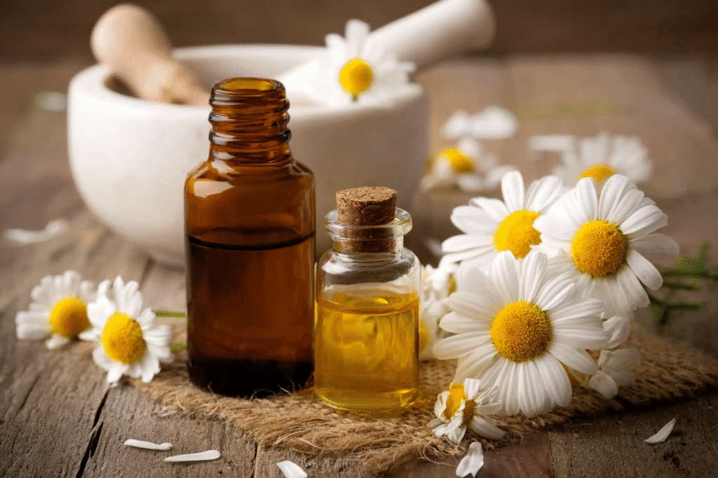 Bottle of chamomile essential oil with delicate white and yellow chamomile flowers, highlighting its soothing properties.