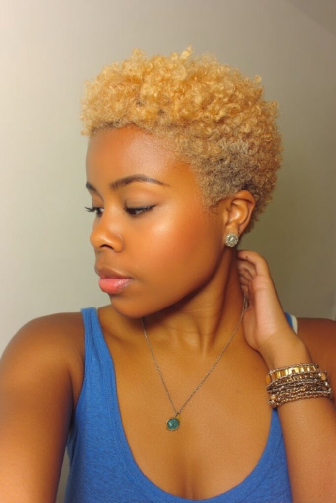 Short natural hair cut close on sides, longer on top, enhanced with vibrant temporary color highlights throughout.