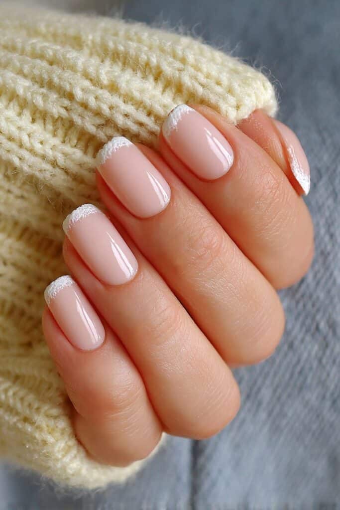 Short summer nails with soft apricot-toned French tips creating minimalist and elegant fresh seasonal manicure vibe design.