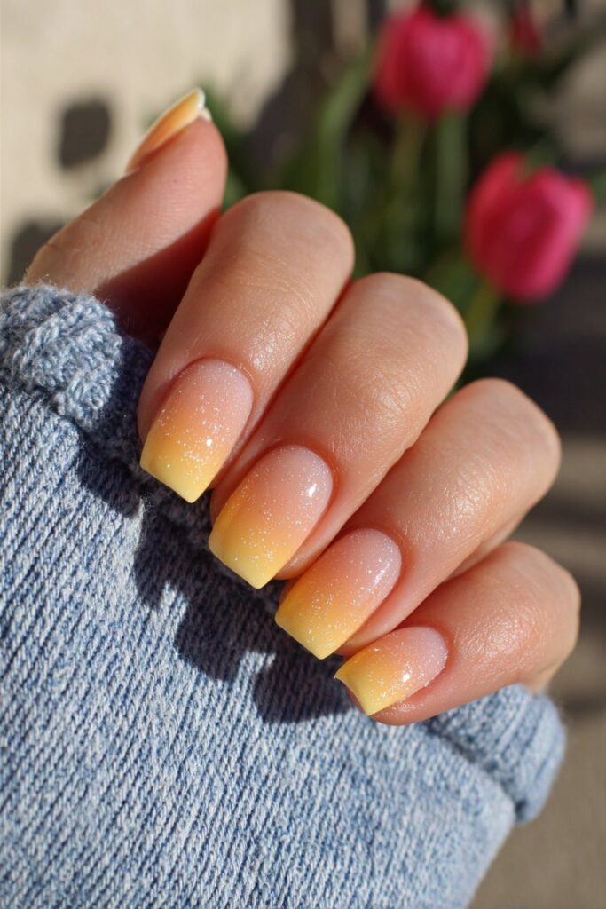 Gradient orange French tips with smooth peach-to-orange transition creating seamless elegant summer-inspired French manicure with color flow.