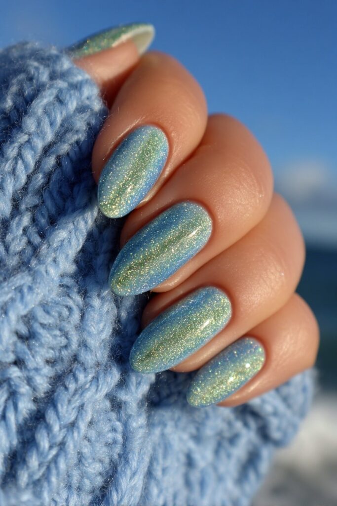 Magnetic cat-eye nails in shimmering emerald and sapphire tones with chrome light reflection.