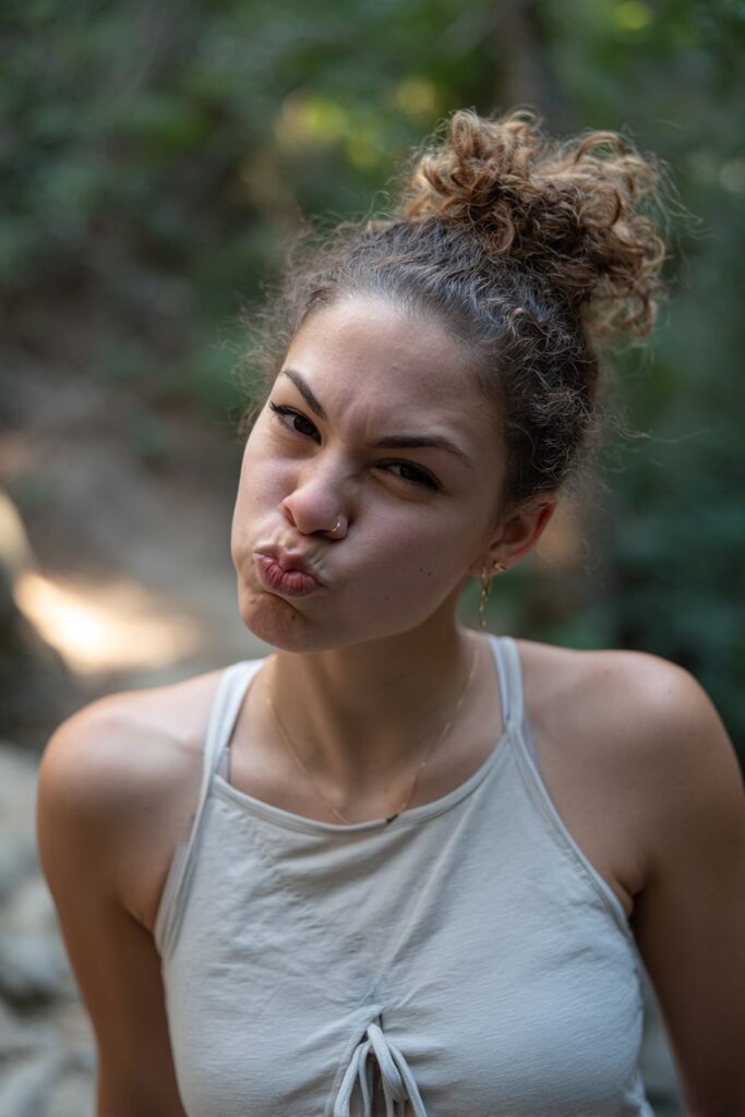 Half-up top knot hairstyle on medium-length hair, combining casual and polished summer styling