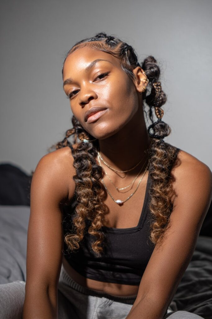 Jayda Wayda-inspired style combining Fulani braids in front with curly crochet hair at the back for volume.