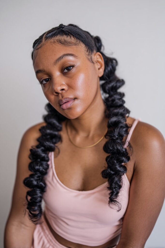Fulani-style braids with spiraled curly tips, neat parting, and styled baby hairs inspired by Jayda Wayda's looks.