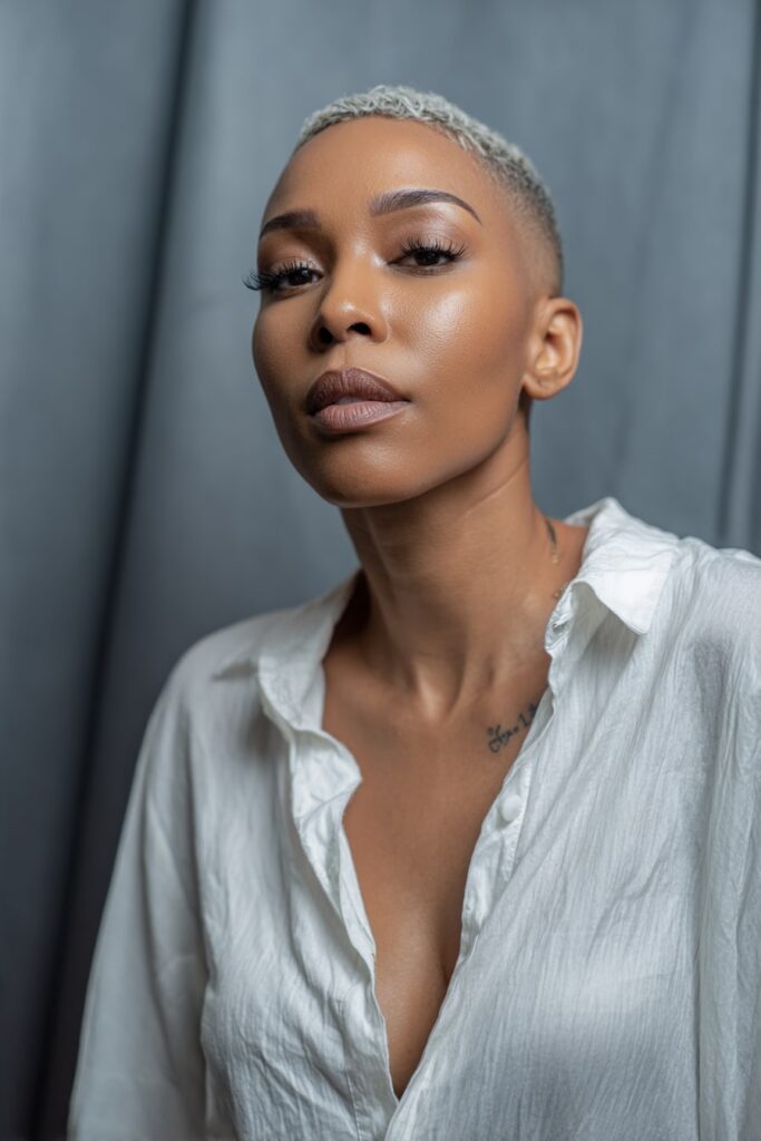 Flawless pixie cut modeled after Jayda Wayda’s signature look—sleek edges, sharp part, subtle lift at the crown, and dramatic lashes.