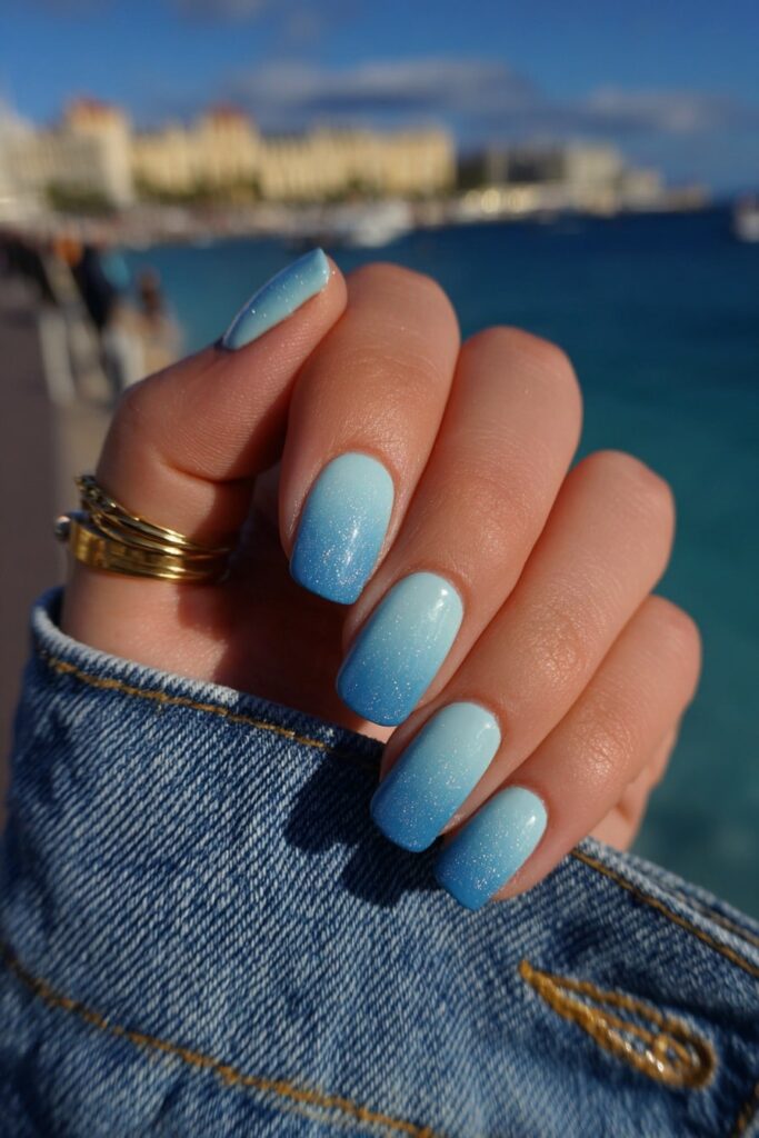 Nails painted in oceanic tones of turquoise and navy, inspired by tropical sea depths.