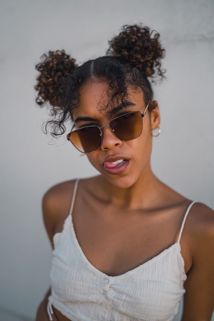 Playful space buns hairstyle on medium-length hair, trendy double bun summer updo