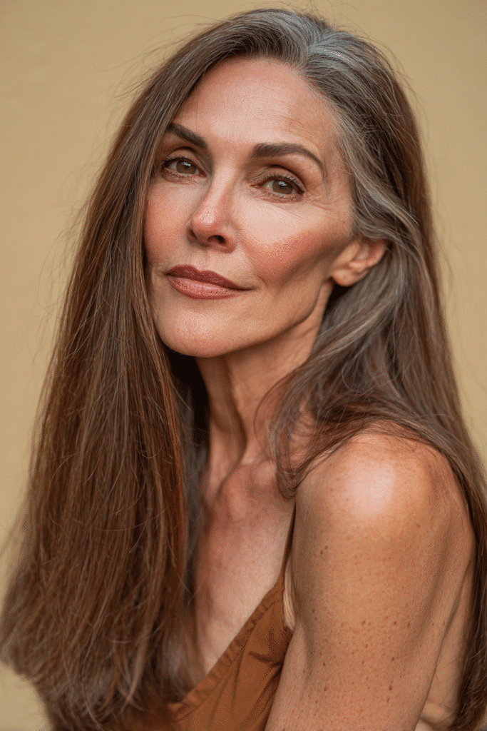 A classic U-shaped haircut in a rich chocolate brown color, with smooth, even layers cascading down the back. The look is polished and timeless, photographed under natural lighting to highlight the silky texture.