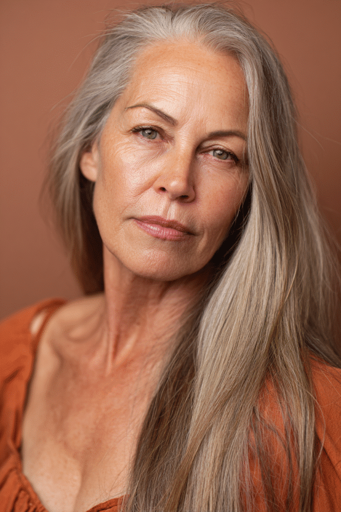 A modern long bob haircut with delicate, face-framing highlights adding dimension to the style. The look is sleek and slightly textured, shot against a bright and airy background.