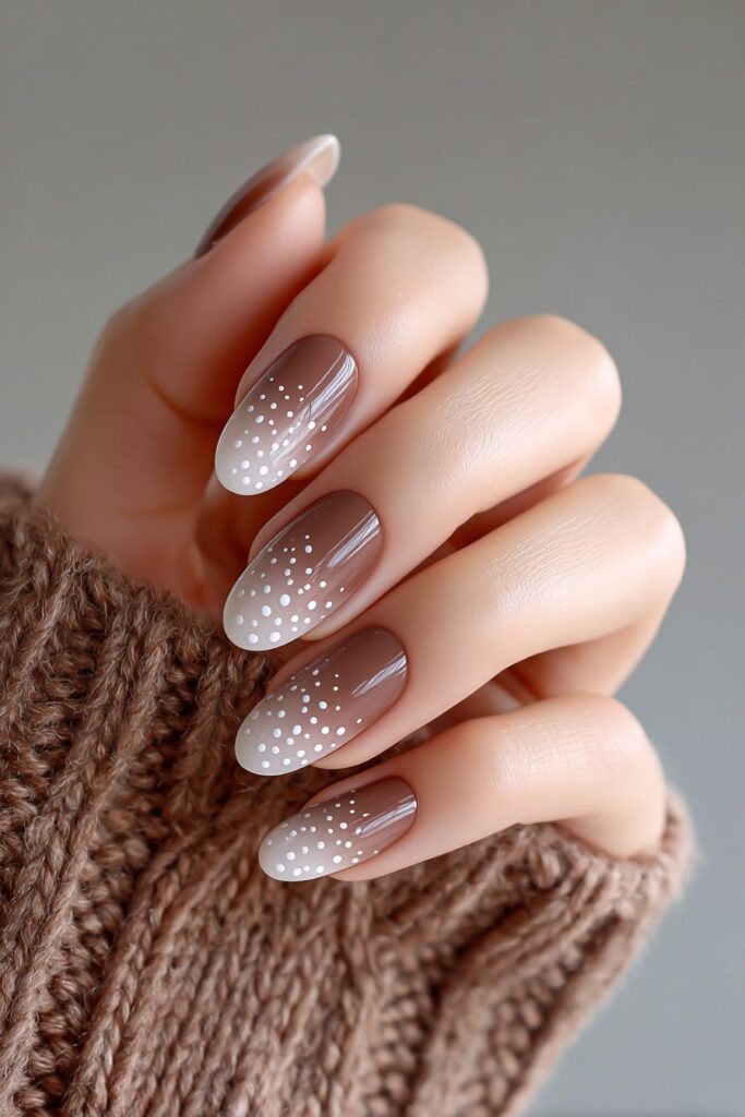 Dreamy brown aura gradient nails with soft white dot fade, creating a magical ombre effect, long oval nails with a glossy sheen and modern charm.