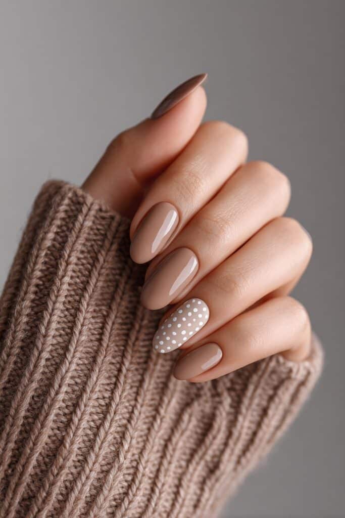 Elegant mix of neutral brown tones with beige, taupe, and white dots, short rounded nails in glossy finish for a calm, sophisticated vibe.