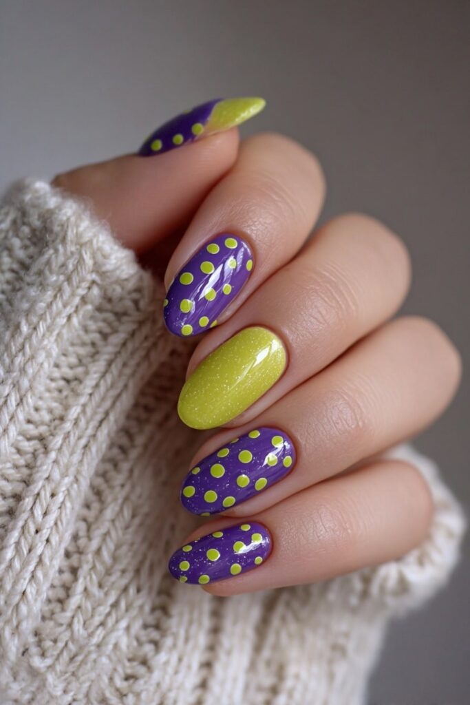 Witch-inspired Halloween nails featuring playful purple and green polka dots for eerie charm.