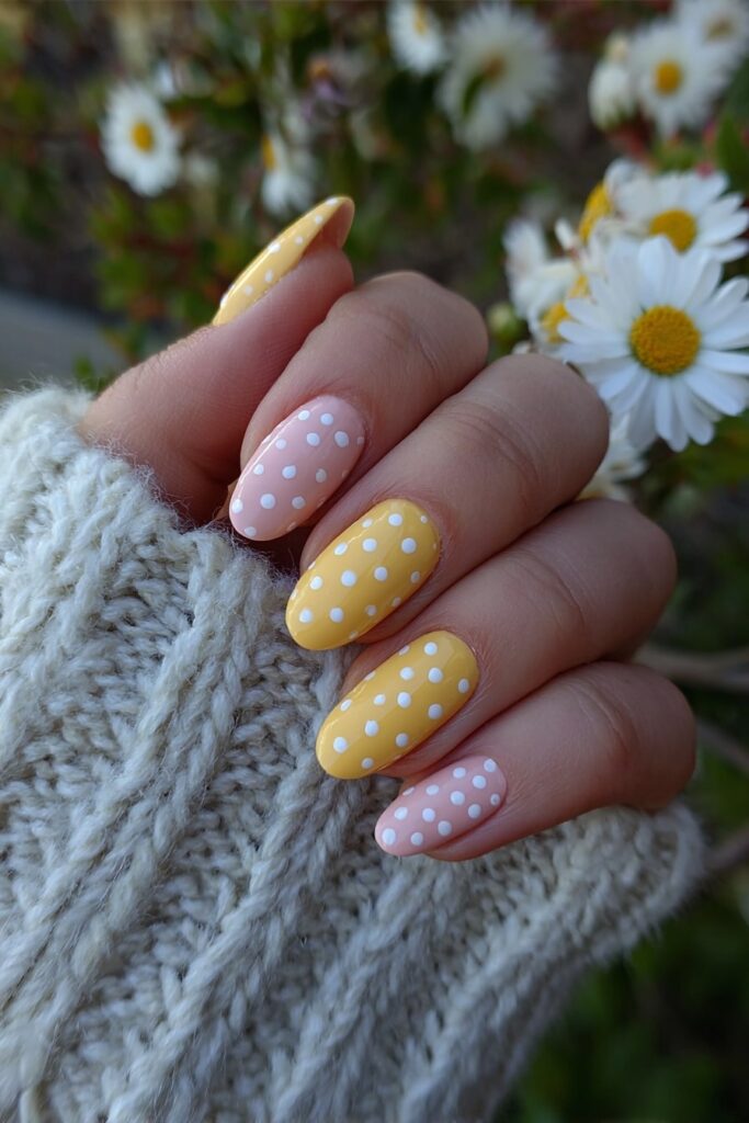 Retro pink and yellow polka dot nails with a fun vintage summer vibe.