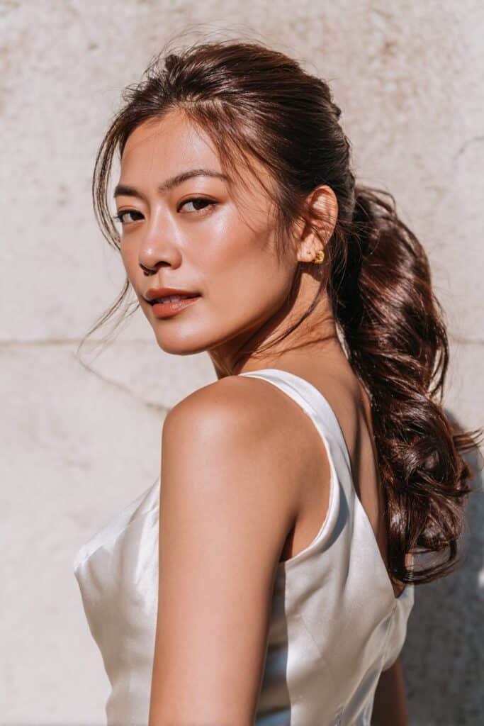 A sleek and polished low ponytail designed for thin fine hair, with subtle lift at the crown for a fuller bridal look.