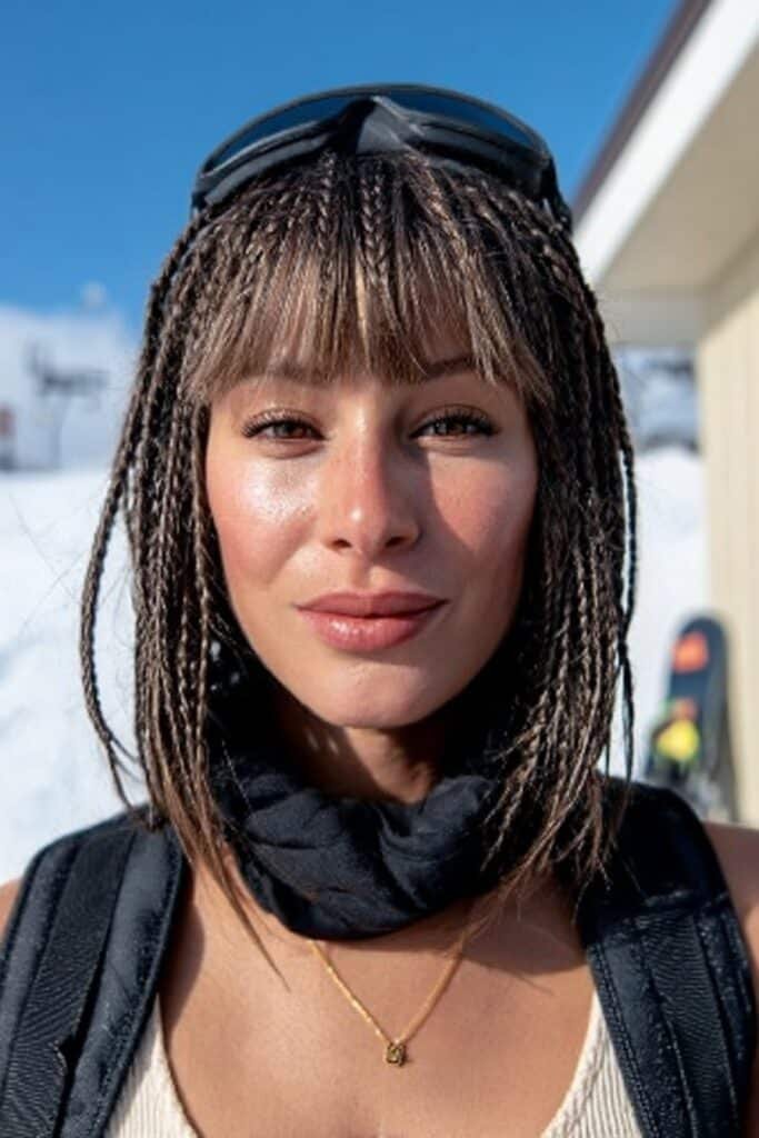 Boxer braids snowboarding hairstyle with wispy bangs